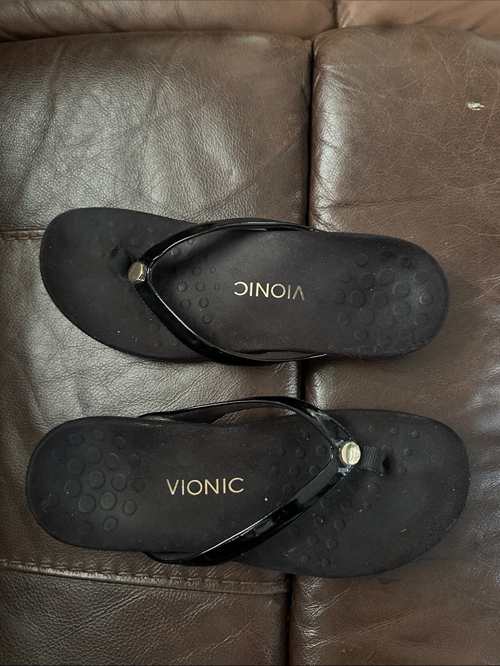 Vionic woman’s black sandals with gold accents